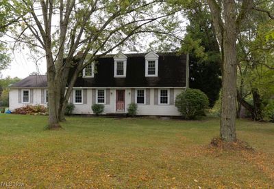 New england style home with a front lawn | Image 1