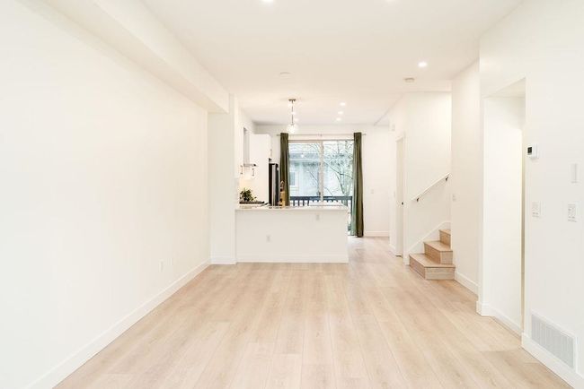 Spare room with stairway, recessed lighting, baseboards, light wood-style floors, and visible vents | Image 15