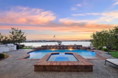 DRAMATIC FRONT ELEVATION WITH UPLIGHTING AND LUSH LANDSCAPING COMBINED WITH MEDITERRANEAN ARCHITECTURE TO CREATE A BEAUTIFUL CURB APPEAL. | Image 2