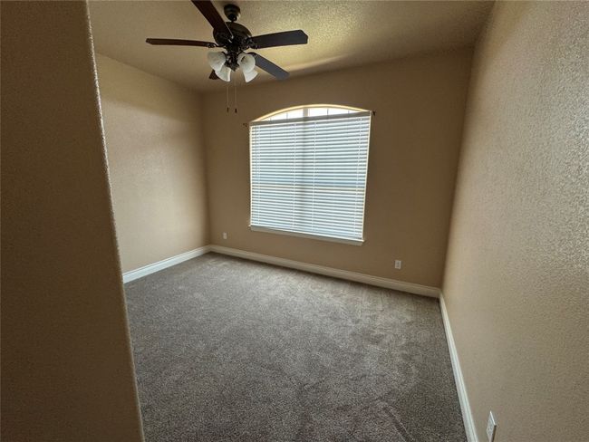Unfurnished 3 room featuring carpet, baseboards, a textured wall, and ceiling fan | Image 15