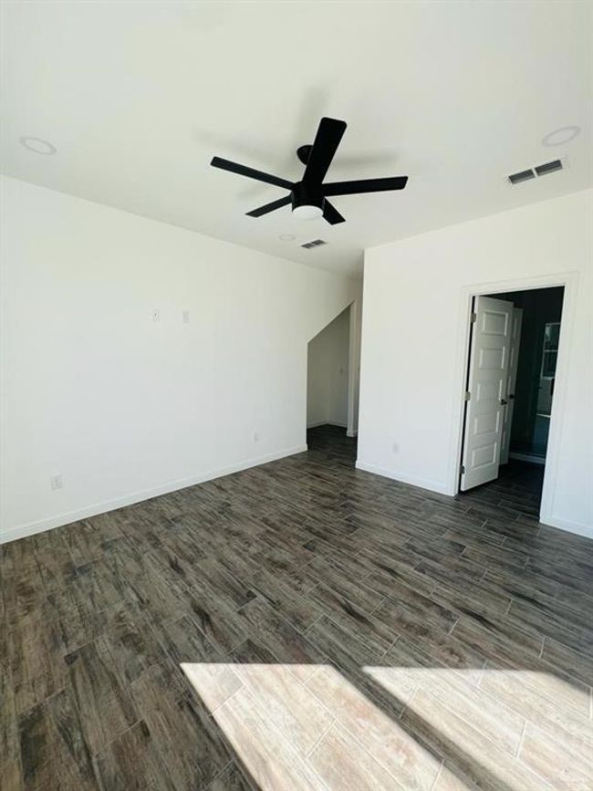 Unfurnished room with dark hardwood / wood-style flooring and ceiling fan | Image 14