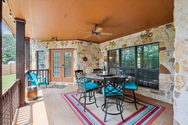 This back, covered porch is an awesome space to entertain. | Image 28