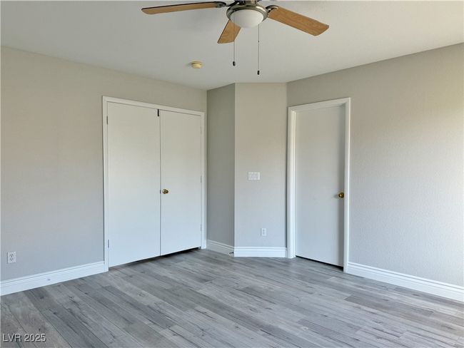 Unfurnished bedroom featuring light wood-type flooring, baseboards, a closet, and a ceiling fan | Image 25