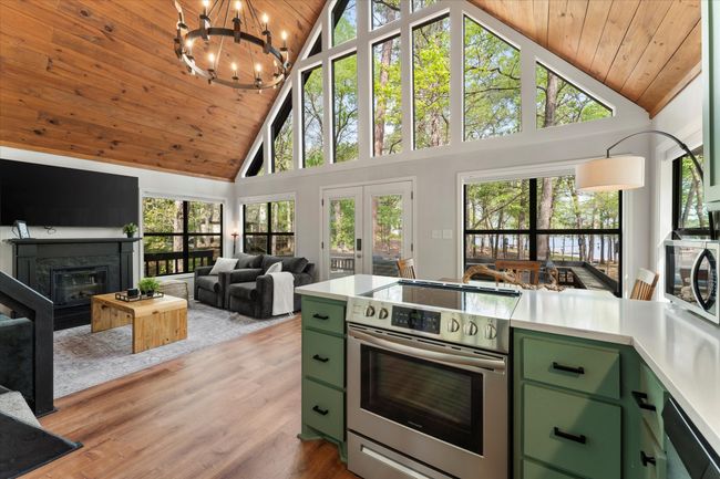 Kitchen with wood ceiling, stainless steel appliances, and green cabinetry | Image 25