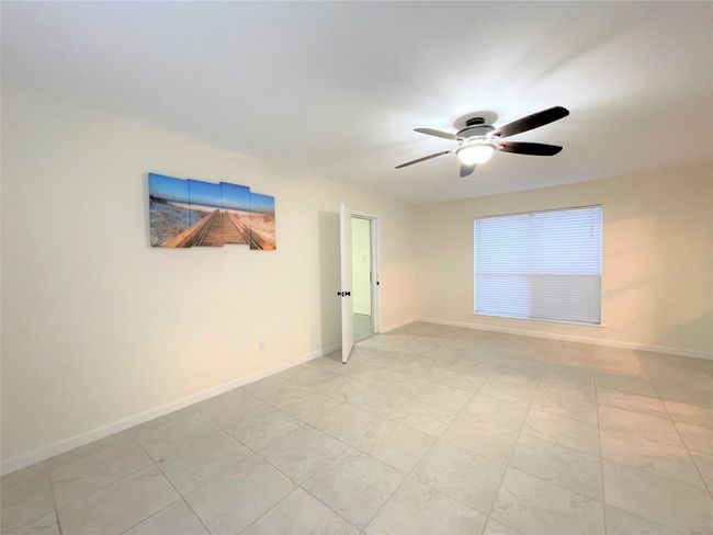 Empty room featuring ceiling fan and baseboards | Image 16