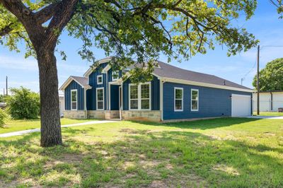 View of front of home featuring a garage and a front lawn | Image 1