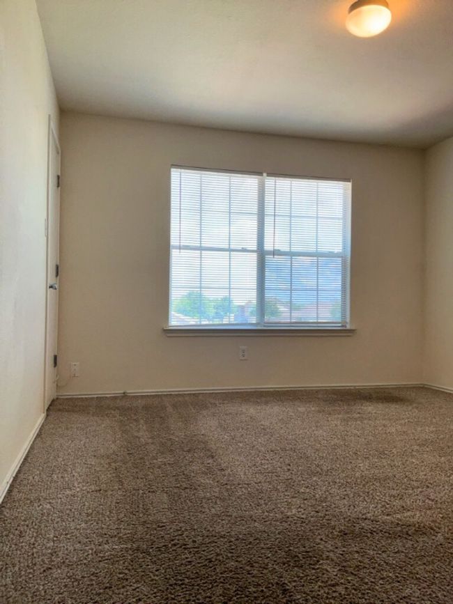 Carpeted bedroom featuring baseboards | Image 12