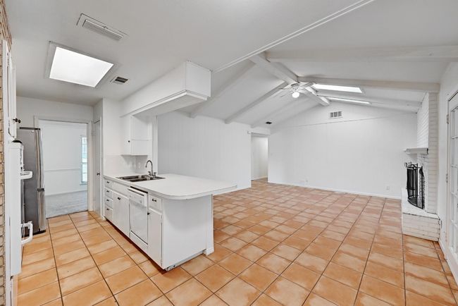 Kitchen featuring a sink, visible vents, a peninsula, and dishwasher | Image 11