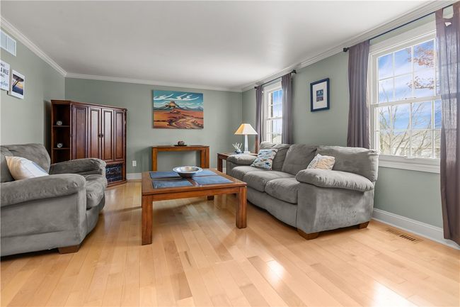 Formal Living Room with gleaming hardwood flooring and elegant crown molding | Image 9