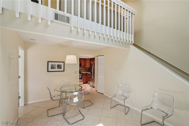 Dining room with light tile patterned floors | Image 12