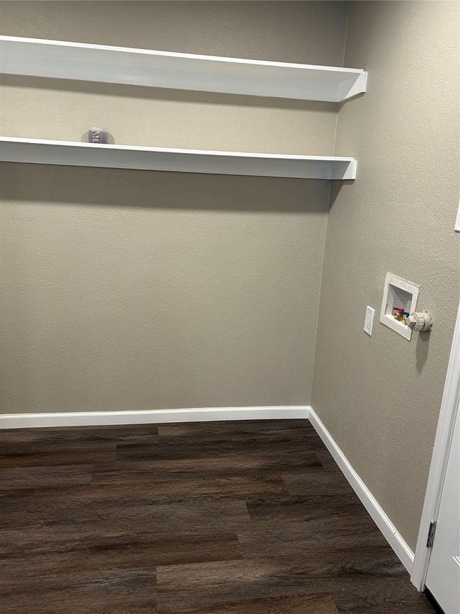 Laundry room with hookup for a washing machine, dark wood-style flooring, and baseboards | Image 7