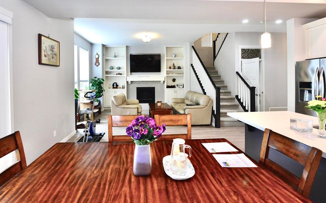 Living room with stairs, a fireplace, wood finished floors, and recessed lighting | Image 20