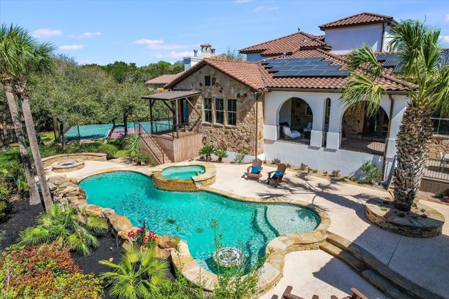 Resort style swimming pool with spa, fire pit area and your own private sport court. The home is fully fenced. | Image 7
