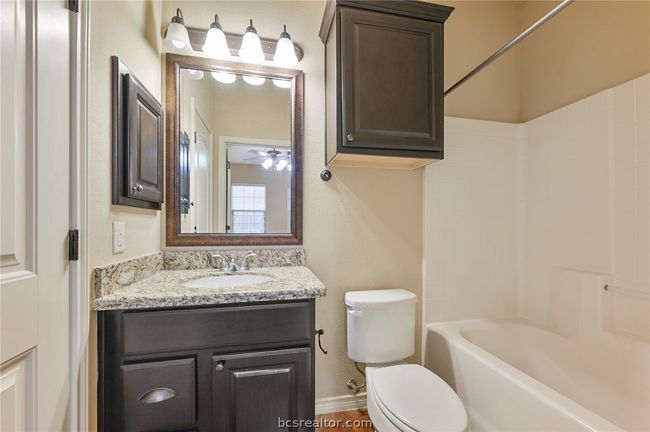 Full bath with shower / bathing tub combination, vanity, ceiling fan, baseboards, and toilet | Image 8