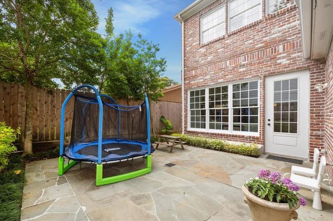 Recent add flagstone in this paved backyard. Backyard is easily visible from kitchen and family room. Lots of possibilities with this space. Turf for more yard space for play. Add al fresco lighting for evening enjoyment! | Image 28