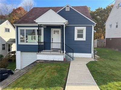 View of front of house featuring a garage and a front lawn | Image 1