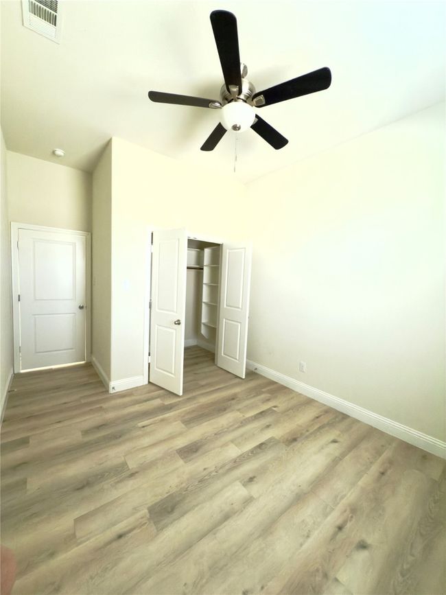 Unfurnished bedroom with baseboards, light wood finished floors, and a closet | Image 14