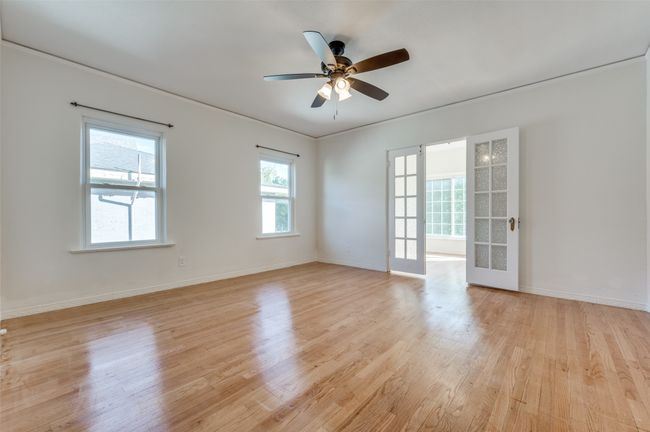 Unfurnished room with light wood finished floors, a ceiling fan, and baseboards | Image 23