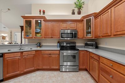 Kitchen cabinets galore! So smart to have the added cabinetry along the wall in the kitchen! Plus you have a pantry and closet within the kitchen, too! | Image 2