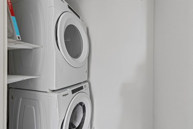 Clothes washing area with stacked washer and clothes dryer | Image 17