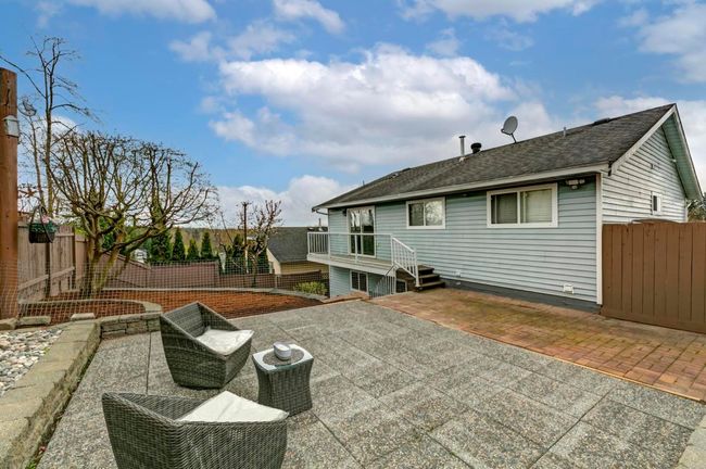 Back of house with a fenced backyard, a patio area, and a shingled roof | Image 32