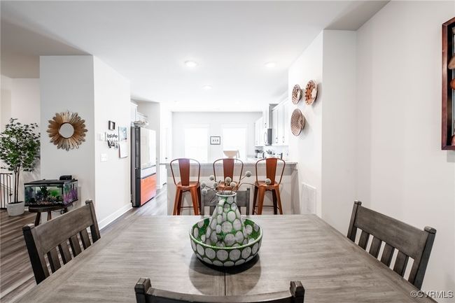 Dining area featuring light wood finished floors and recessed lighting | Image 14
