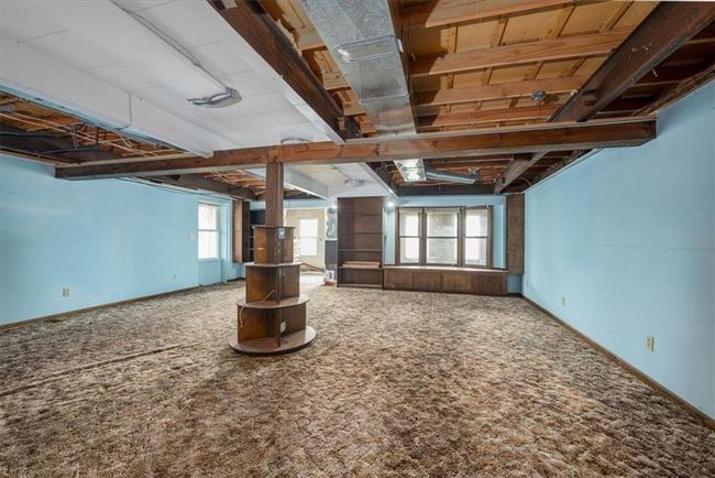 Below grade area featuring baseboards, a wealth of natural light, and carpet | Image 25