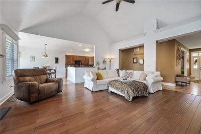 An inviting entry leads into the spacious family room. Tall cathedral ceilings provide the perfect accent to this room. Gorgeous engineered hardwood floors provide warmth to the room. | Image 2