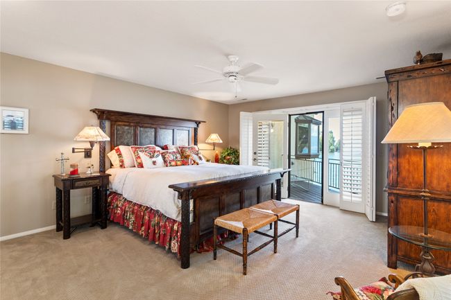 Bedroom with access to exterior, light colored carpet, multiple windows, and a ceiling fan | Image 22