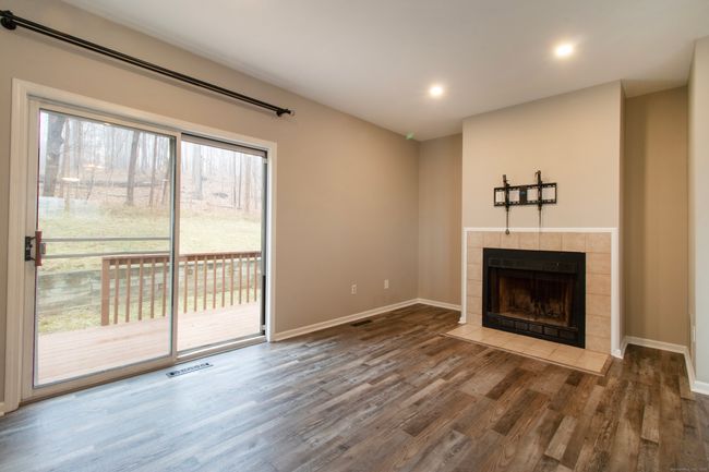 Spacious living room with fireplace and sliders to the back deck! | Image 11