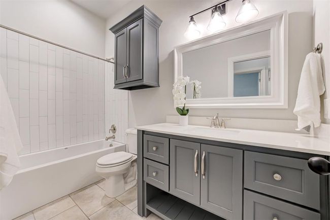 large bathroom with plenty of storage and tub/shower combo. | Image 23