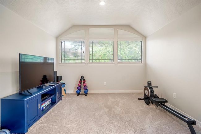 Slightly elevated is this flex space which this family are using as an exercise area. | Image 28