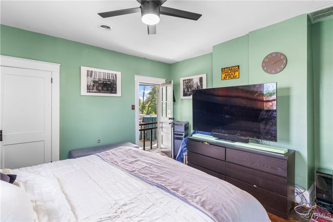Bedroom featuring ceiling fan, access to exterior, and visible vents | Image 32