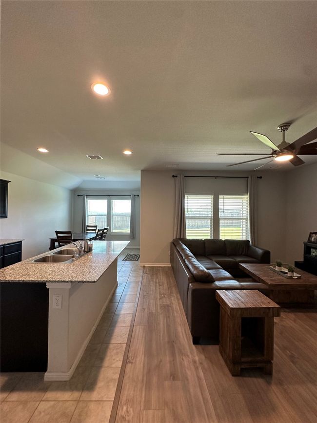 Living area with recessed lighting, light wood finished floors, and a ceiling fan | Image 15