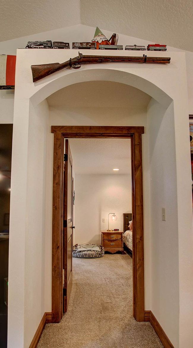 Hallway featuring carpet floors, baseboards, and a textured ceiling | Image 17