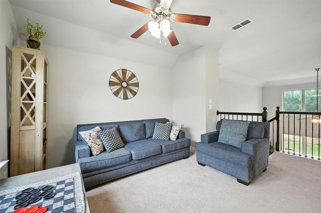 Upstairs living room featuring a ceiling fan | Image 20