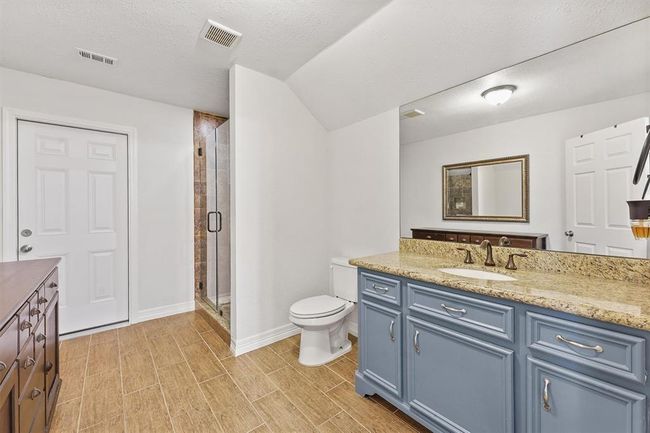 Clean and contemporary design with a large walk-in shower—offering both style and functionality. | Image 16