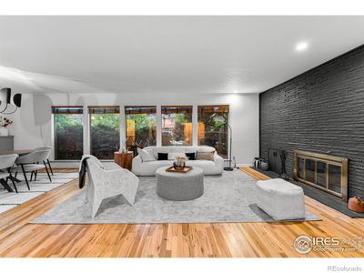 Rich warm floors and floor to ceiling brick fireplace add character. | Image 1