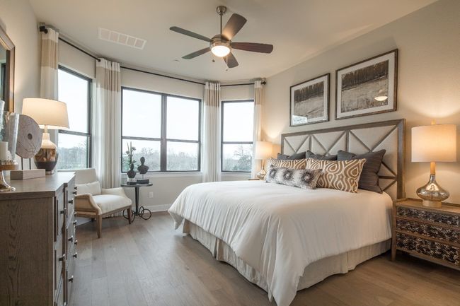 Bedroom featuring wood finished floors, multiple windows, and baseboards | Image 17