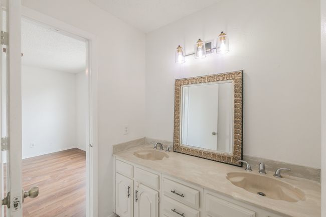 Full bathroom featuring double vanity and wood finished floors | Image 13