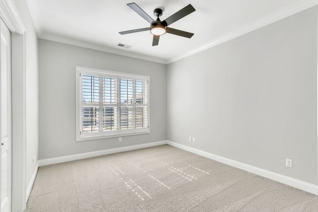 The fourth bedroom has a walk-in closet. All the bedrooms have five inch wood shutters & offer ceiling fan light fixtures. | Image 41