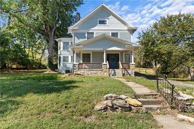 View of front facade featuring a front lawn and a porch | Image 1