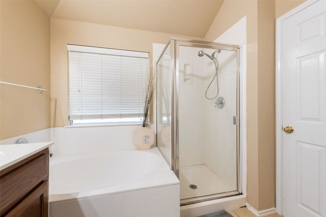 Full bath featuring a shower stall, a bath, and vanity | Image 20