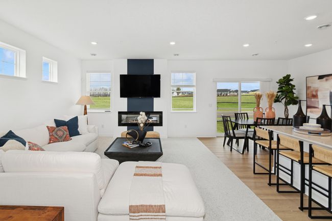 (Photo of decorated model, actual home's finishes will vary) A beautiful electric fireplace completes the great room. | Image 9