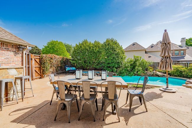 View of swimming pool with a gate, a fenced in pool, a patio, and a fenced backyard | Image 33