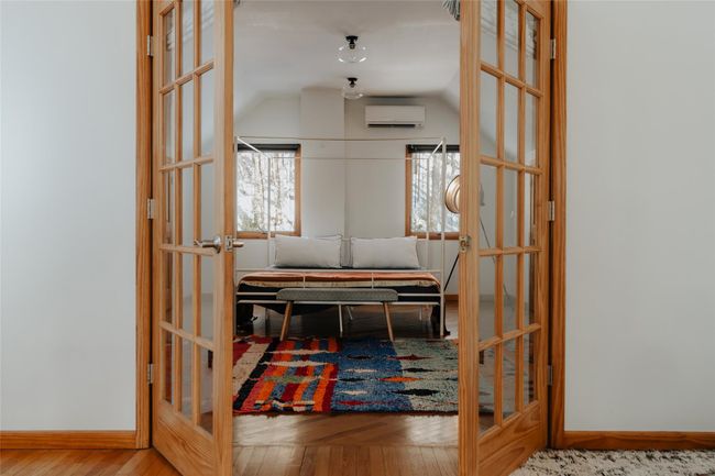 Corridor with hardwood / wood-style floors, vaulted ceiling, french doors, and a wall mounted AC | Image 20