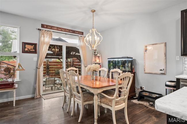 Dining space featuring a chandelier and dark wood-style flooring | Image 8