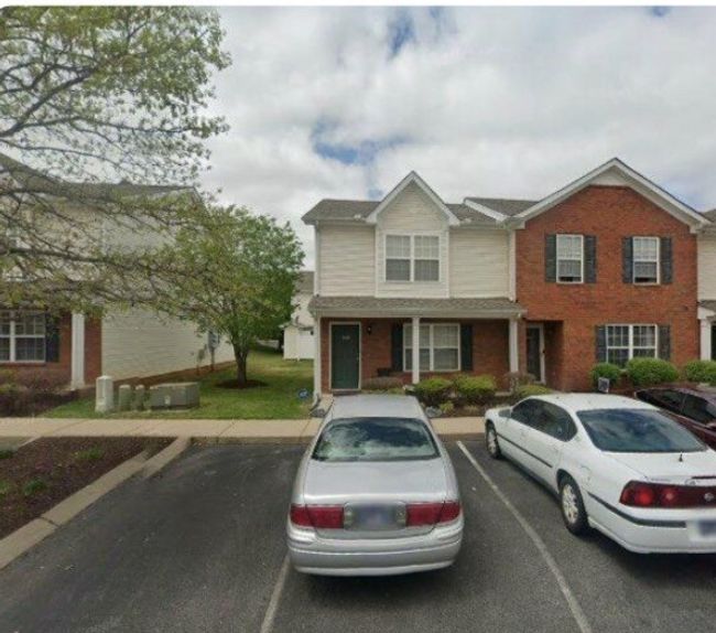 Plenty of parking spaces to accommodate this end unit townhome with covered front porch, enclosed patio with a storage room. 2 ensuite bedrooms UP with ½ bath down...extra large kitchen and living room. Utility room downstairs as well. | Image 46