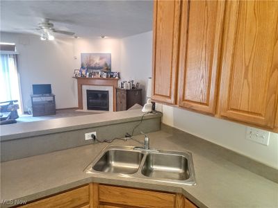 Kitchen featuring ceiling fan and sink | Image 3