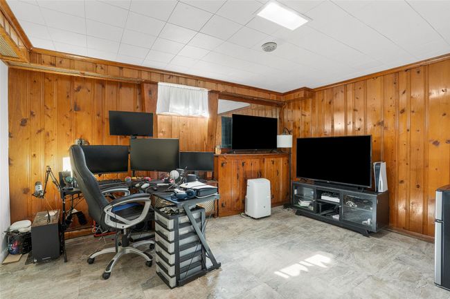 Home office with wood walls and light flooring | Image 18
